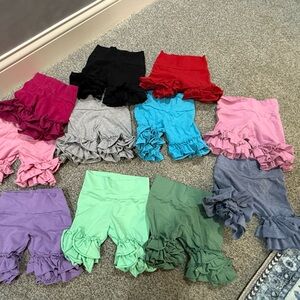 Lot of 11 pairs of Kpea ruffle shorts. 2T